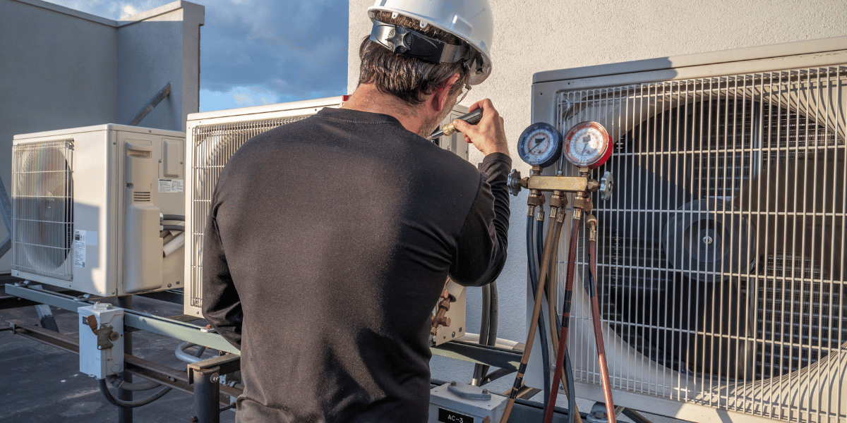 technician working on an air conditioning unit