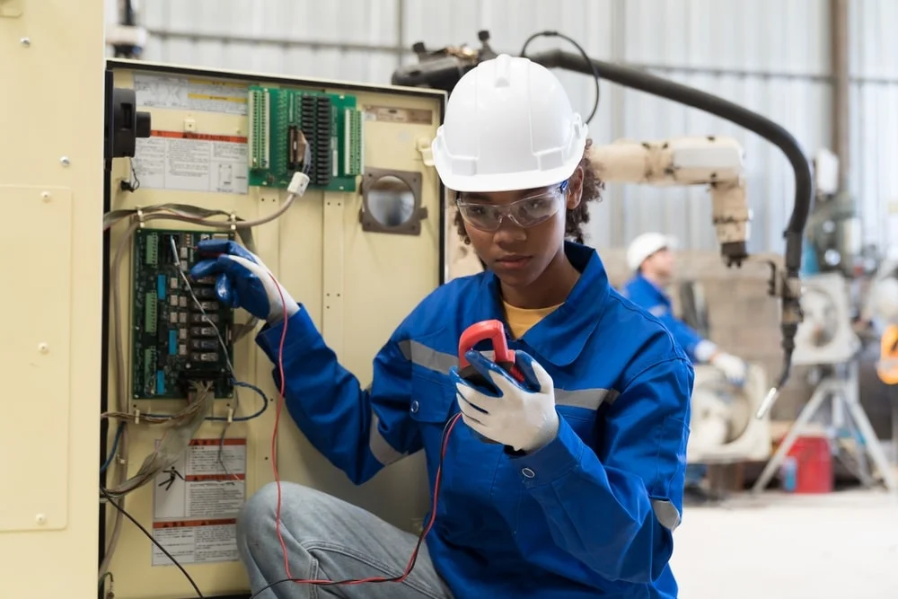 woman electrical technician testing a voltage