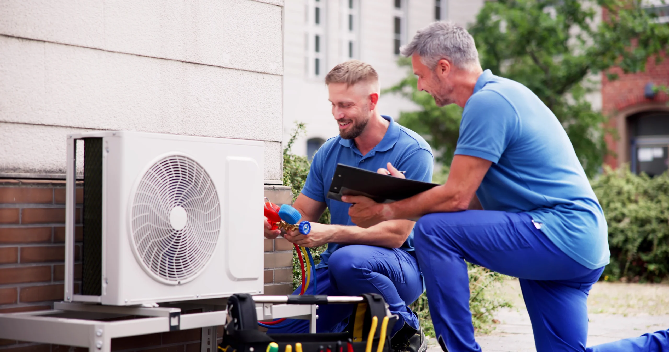 2 men working on HVAC system