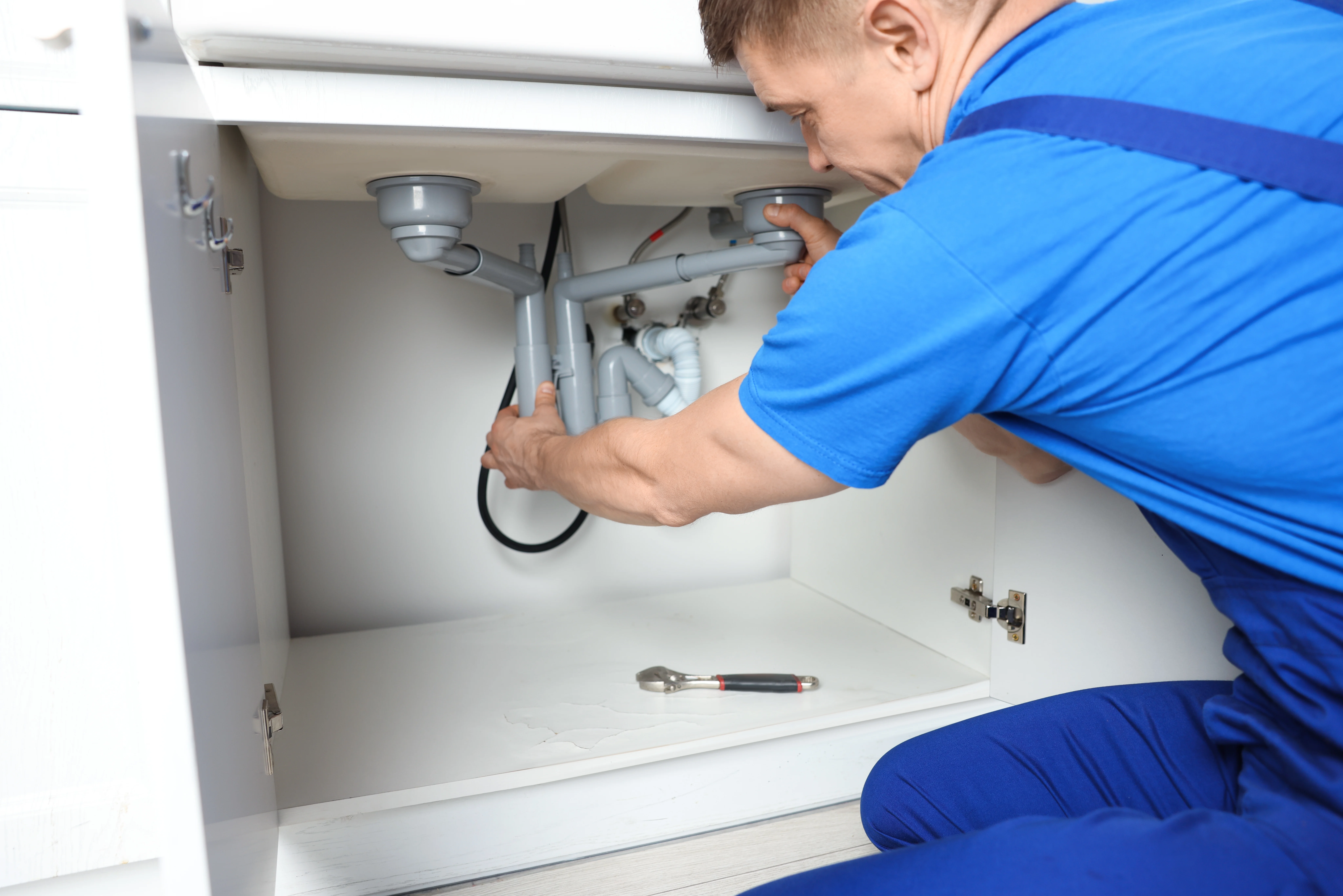 Plumbing technician working on a sink