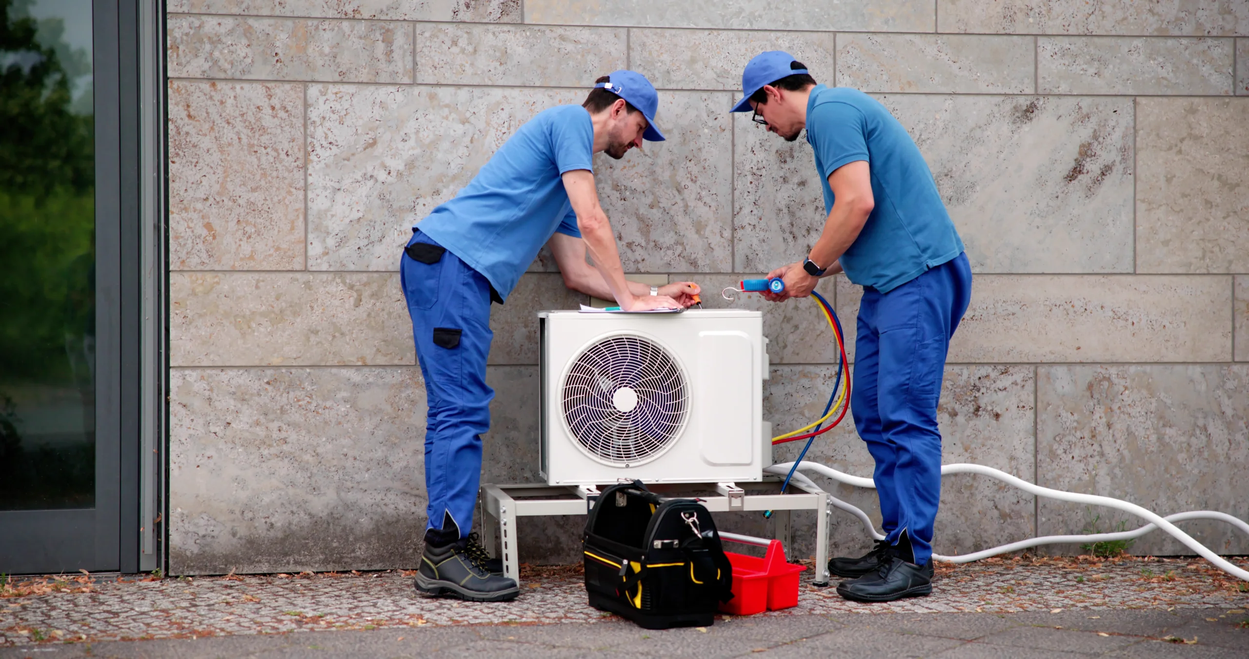 2 men working on HVAC system