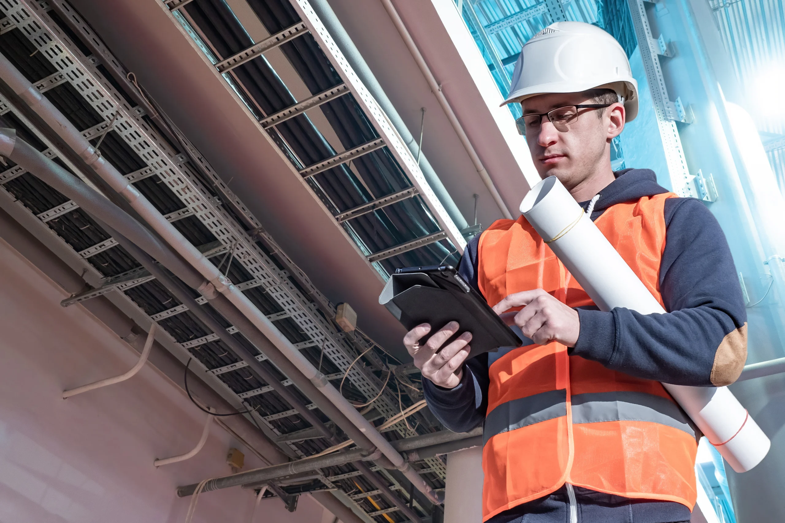 electrical project manager looking at tablet